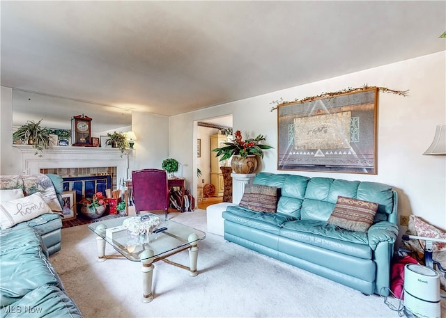 living room featuring carpet flooring and a brick fireplace