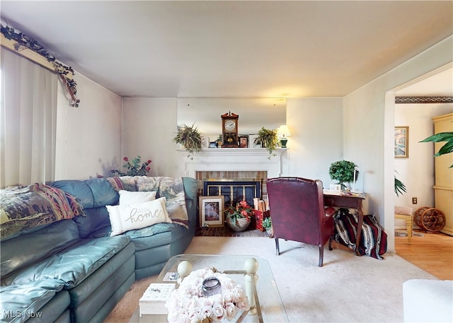 living room featuring wood-type flooring and a fireplace