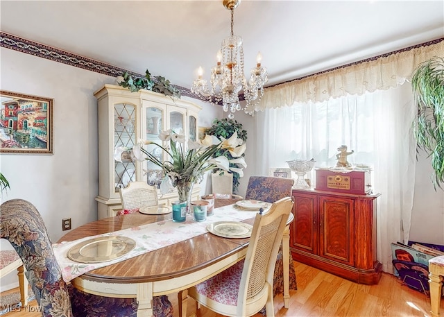 dining room featuring an inviting chandelier and light hardwood / wood-style floors