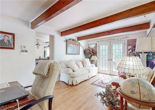 living room with french doors, light hardwood / wood-style flooring, and beam ceiling