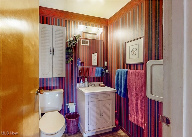 bathroom featuring hardwood / wood-style floors, toilet, and vanity