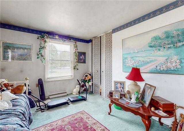 living area featuring a baseboard heating unit and carpet