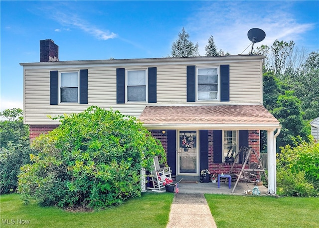 view of front of house with covered porch and a front yard