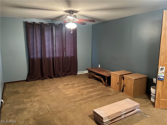 interior space featuring carpet flooring and ceiling fan