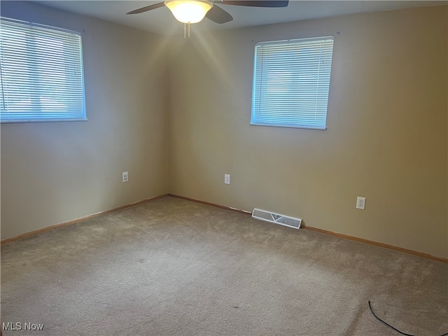 empty room with carpet flooring and ceiling fan