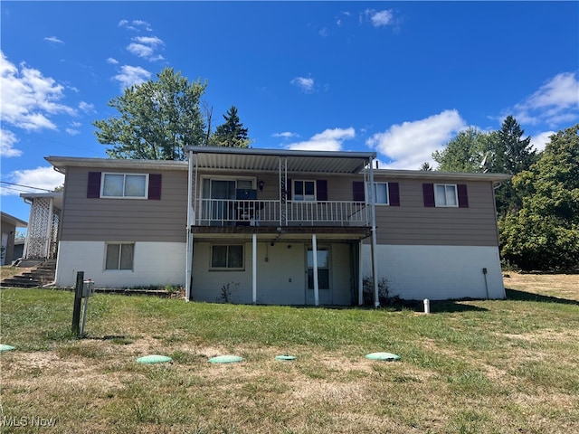 back of house with a lawn