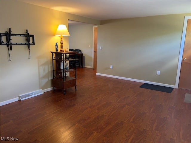 spare room featuring dark hardwood / wood-style flooring