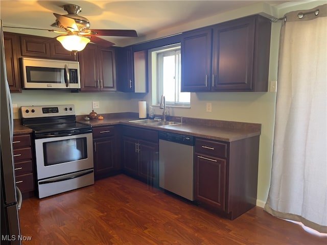 kitchen featuring ceiling fan, dark hardwood / wood-style flooring, stainless steel appliances, and sink