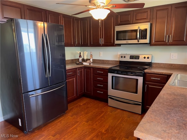 kitchen with ceiling fan, stainless steel appliances, and dark hardwood / wood-style flooring