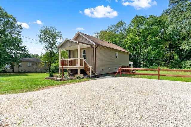 view of front of home with a front yard and covered porch