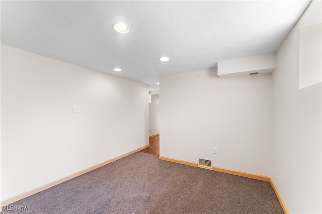 basement with a textured ceiling and carpet floors