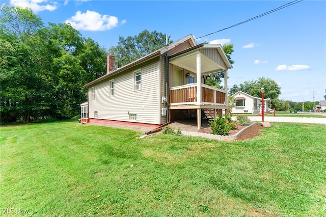 rear view of house with a lawn