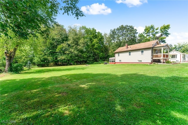 view of yard featuring a wooden deck