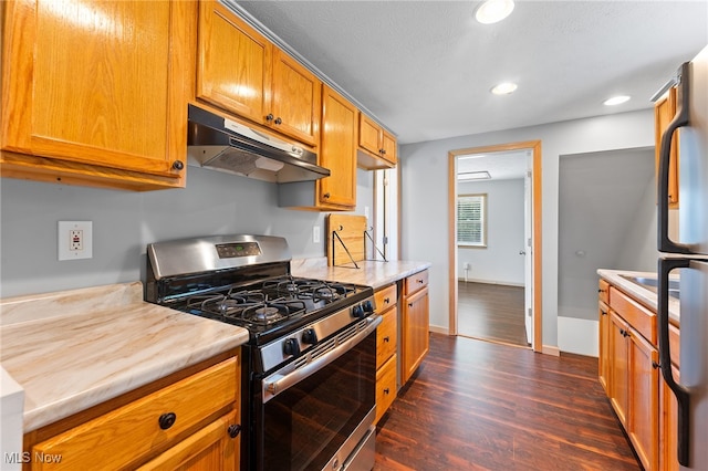 kitchen with gas stove and dark hardwood / wood-style flooring