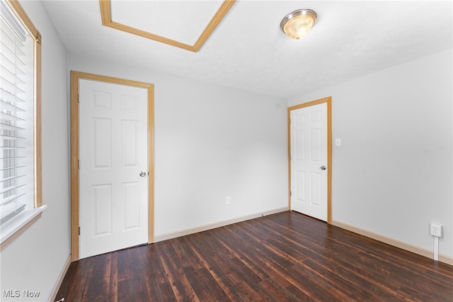 unfurnished room with dark hardwood / wood-style floors