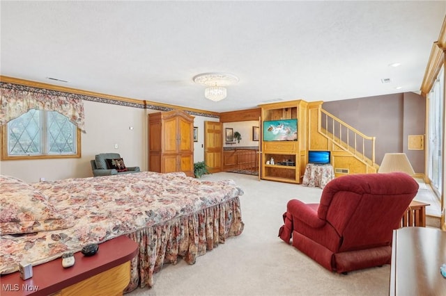 carpeted bedroom with ornamental molding