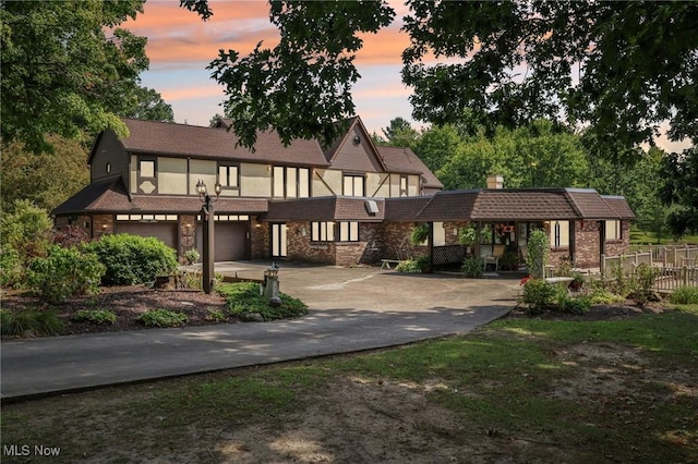 tudor-style house featuring a garage