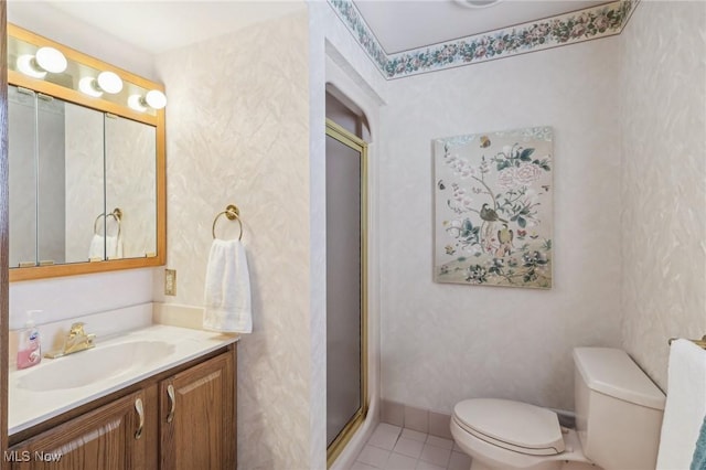 bathroom with vanity, toilet, an enclosed shower, and tile patterned flooring