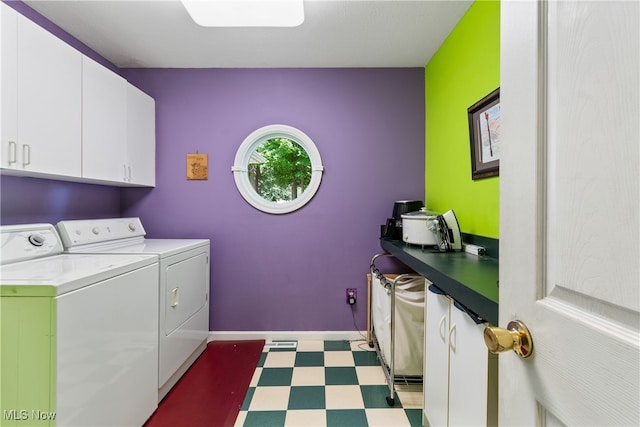 laundry area with washer and clothes dryer and cabinets