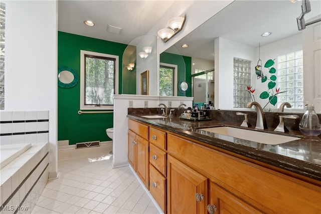 full bathroom featuring tile patterned floors, vanity, shower with separate bathtub, and toilet