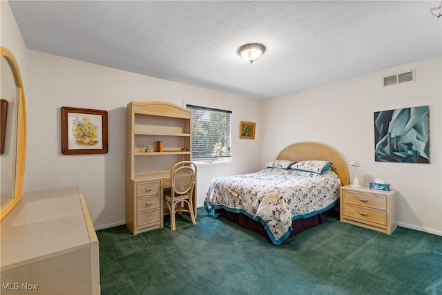 bedroom with dark colored carpet and a textured ceiling