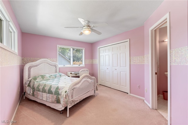 carpeted bedroom featuring ceiling fan and a closet