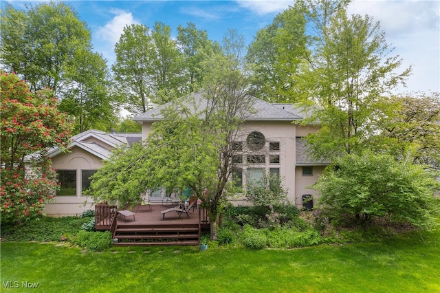 back of house featuring a yard and a deck