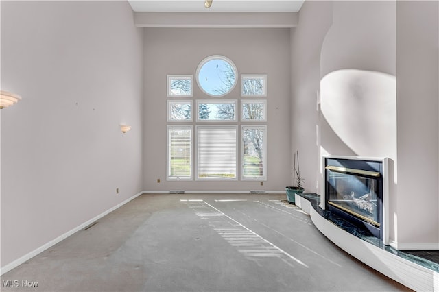 living room featuring carpet and a high ceiling