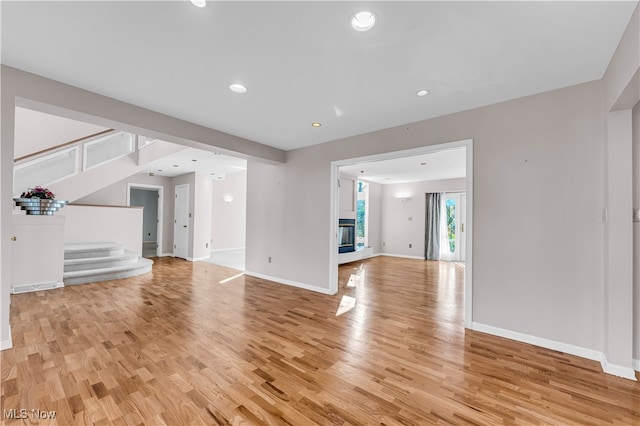 unfurnished living room featuring light wood-type flooring