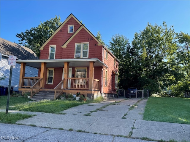 view of front of house featuring covered porch and a front lawn