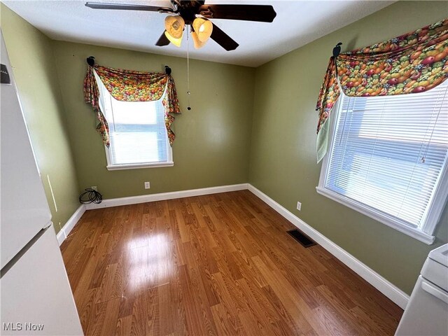 empty room with ceiling fan and wood-type flooring