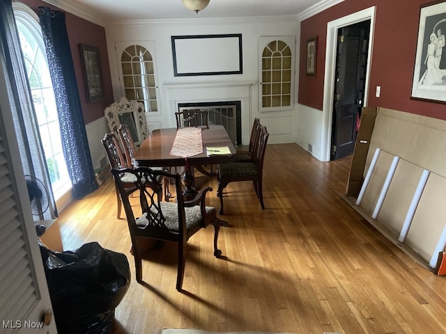 dining room featuring crown molding and hardwood / wood-style flooring