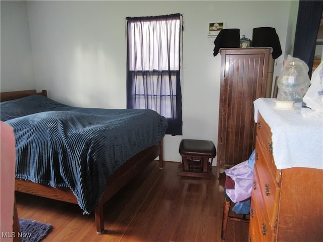 bedroom featuring dark wood-type flooring