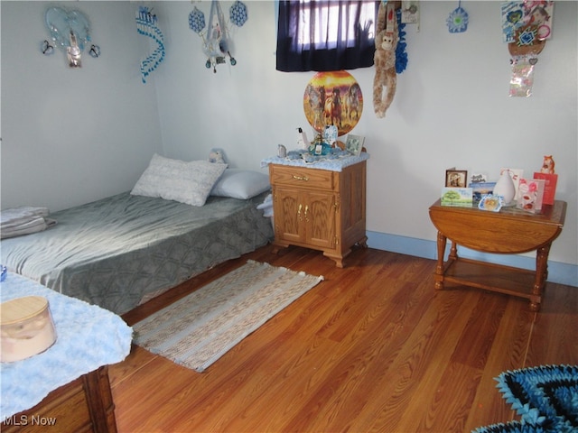 bedroom with hardwood / wood-style floors