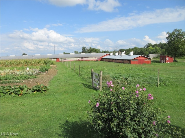 view of yard with a rural view and an outbuilding