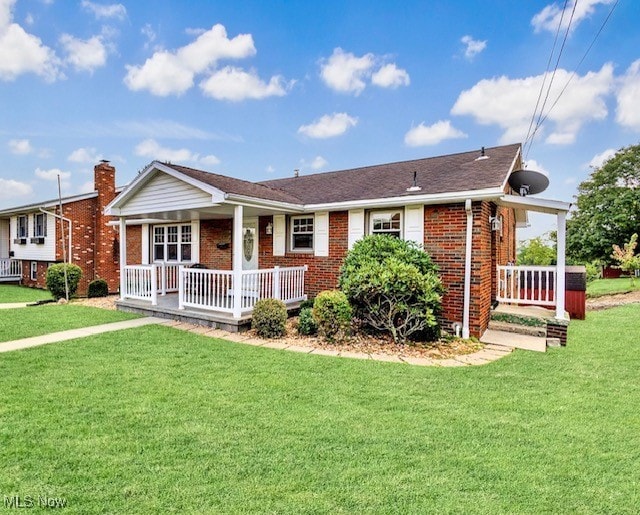 ranch-style home with covered porch and a front lawn