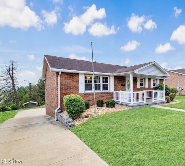 ranch-style home with a front yard and a porch