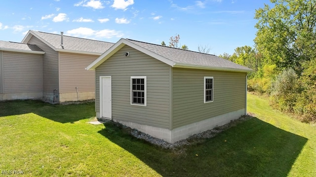 view of outbuilding featuring a lawn