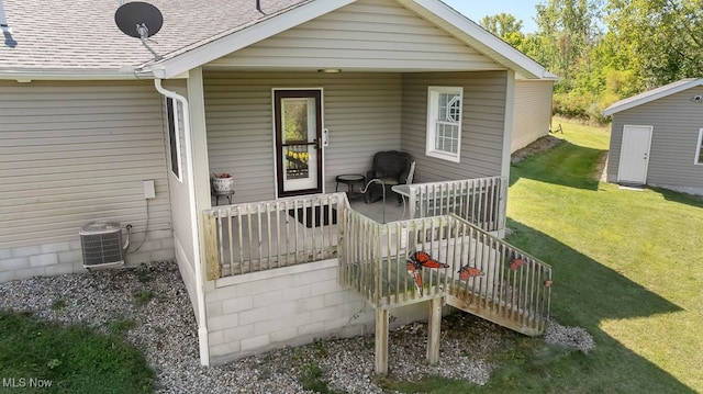 rear view of house with a lawn, central air condition unit, and a wooden deck