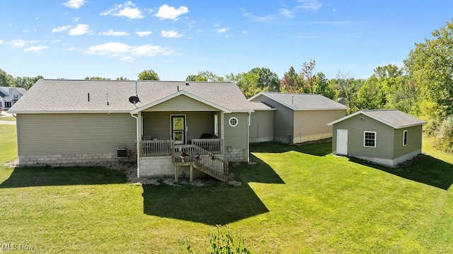 rear view of property with an outdoor structure, central AC unit, and a yard