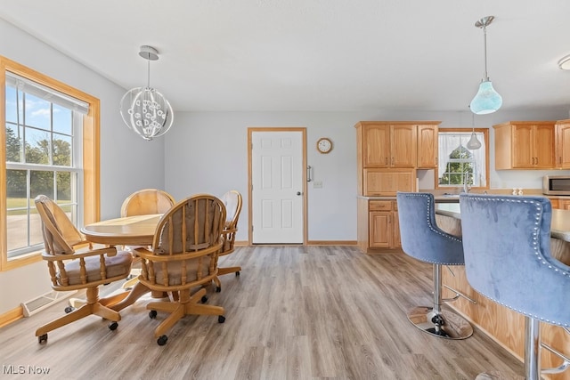 dining space with light hardwood / wood-style flooring