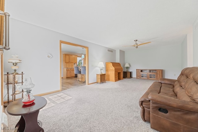 carpeted living room with ceiling fan