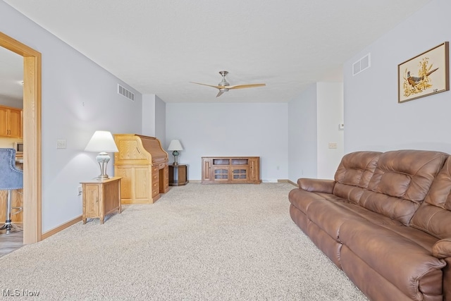 living room featuring light carpet and ceiling fan