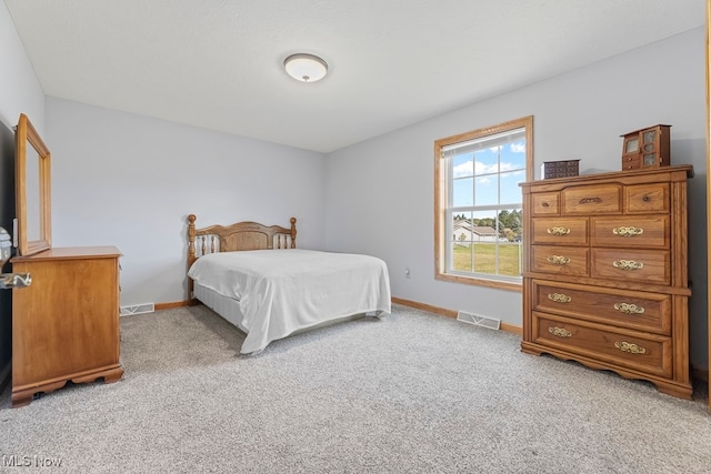 bedroom featuring light carpet