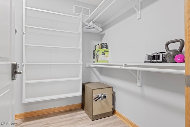 spacious closet featuring light hardwood / wood-style floors