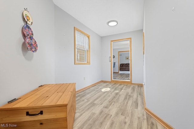 hallway with light hardwood / wood-style flooring