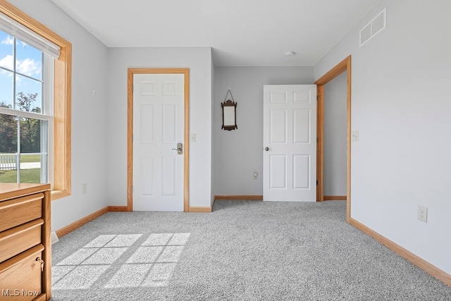 unfurnished bedroom with light colored carpet