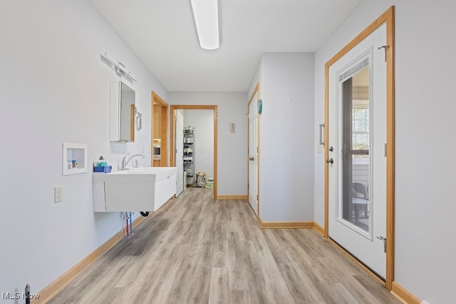 corridor with light hardwood / wood-style flooring