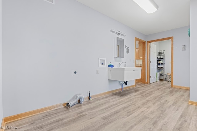 laundry area with light wood-type flooring, washer hookup, and electric dryer hookup