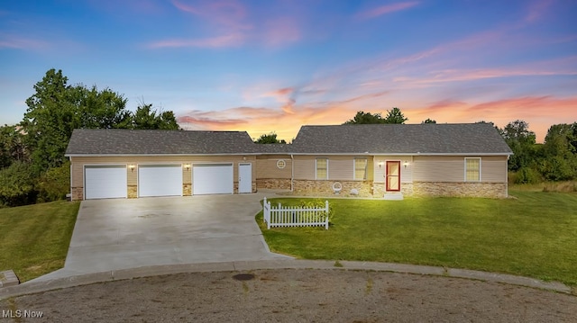 ranch-style home featuring a yard and a garage